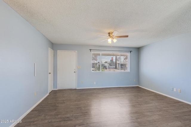 spare room with a ceiling fan, a textured ceiling, baseboards, and wood finished floors