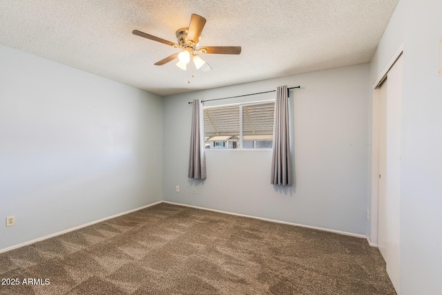 spare room with ceiling fan, a textured ceiling, and carpet flooring