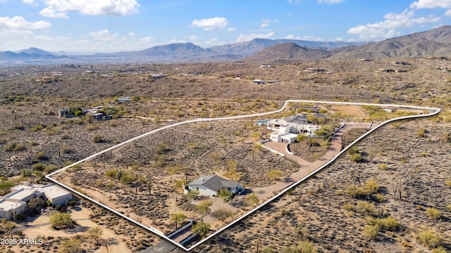 drone / aerial view with a mountain view, a rural view, and view of desert