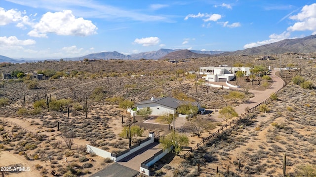 drone / aerial view featuring a mountain view and view of desert