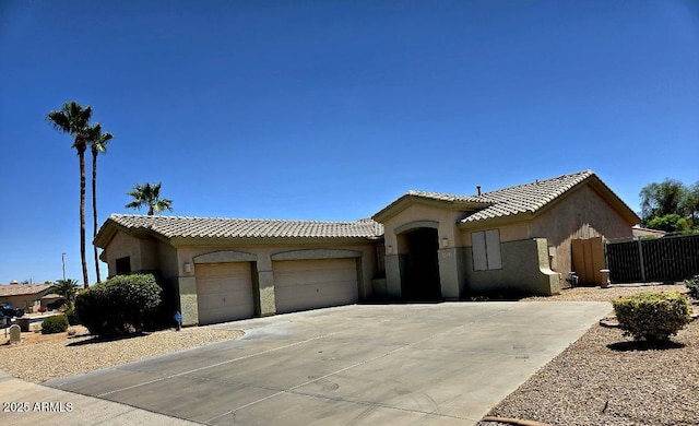 14621 W Catalina Dr, Goodyear, AZ 85395 - view of front of house with an attached garage, driveway, stucco siding, and a tile roof