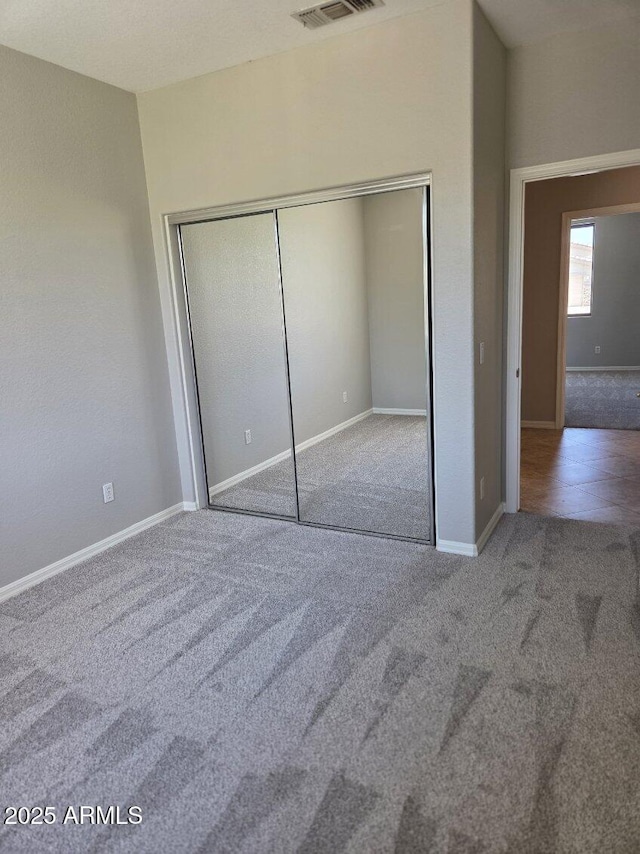 14621 W Catalina Dr, Goodyear, AZ 85395 - unfurnished bedroom featuring carpet floors and a closet