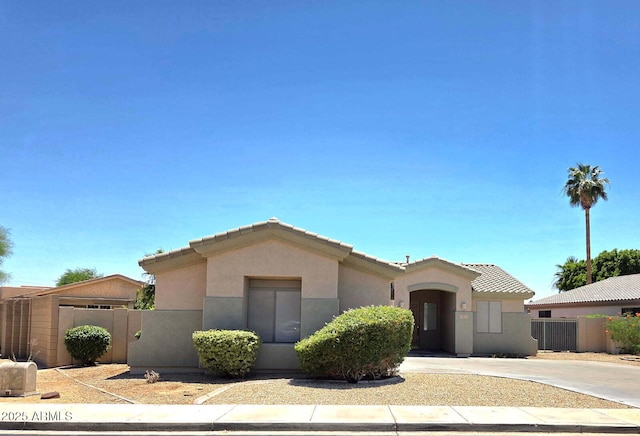 14621 W Catalina Dr, Goodyear, AZ 85395 - view of front of house featuring stucco siding, driveway, and a tile roof