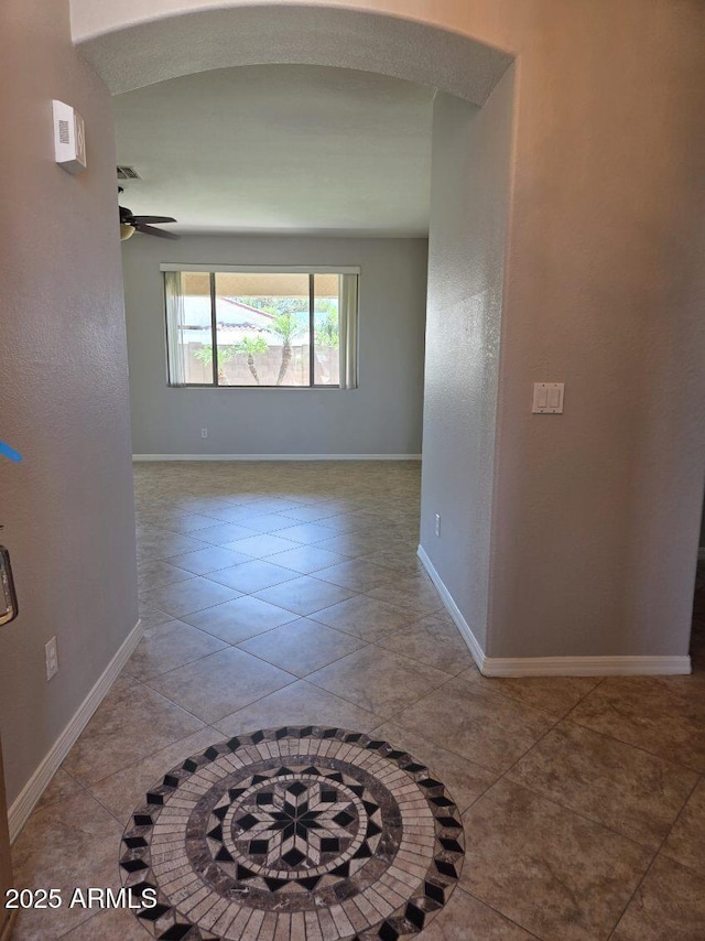 14621 W Catalina Dr, Goodyear, AZ 85395 - tiled empty room with a ceiling fan and baseboards