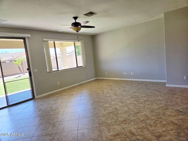 14621 W Catalina Dr, Goodyear, AZ 85395 - tiled empty room featuring healthy amount of natural light and ceiling fan