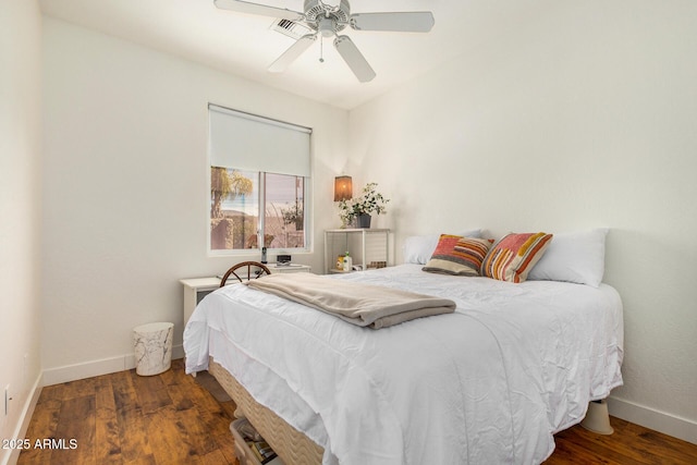 bedroom with ceiling fan, dark wood-style flooring, and baseboards