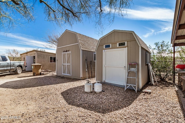 view of shed featuring fence