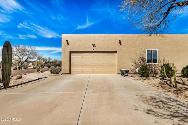 view of property exterior with driveway, an attached garage, and stucco siding