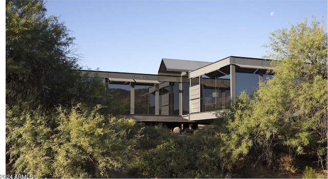 rear view of house with a sunroom