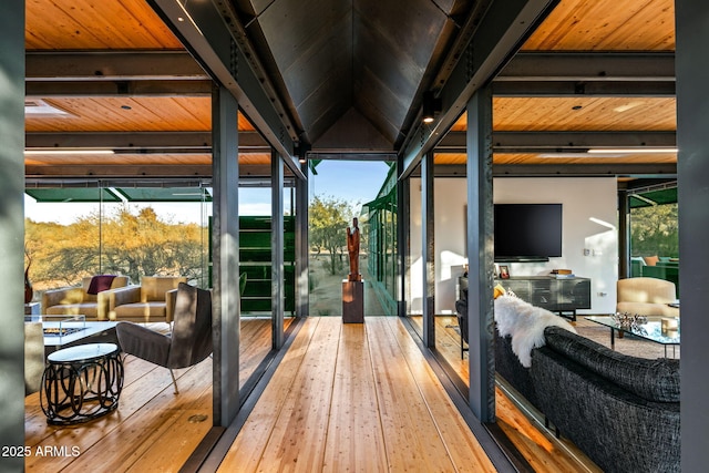 exterior space with vaulted ceiling with beams and hardwood / wood-style flooring