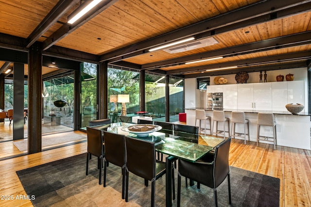 sunroom / solarium featuring beam ceiling