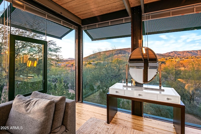 sunroom / solarium with a mountain view and wood ceiling