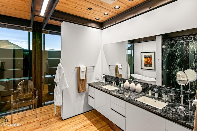 full bathroom featuring wood ceiling, a sink, hardwood / wood-style floors, and double vanity