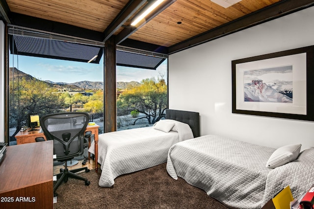 carpeted bedroom featuring wooden ceiling and a mountain view