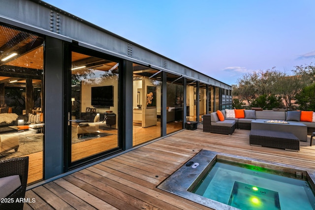 wooden terrace with an outdoor living space with a fire pit