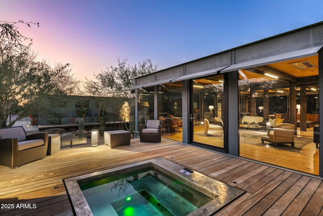 deck at dusk with hot tub deck surround