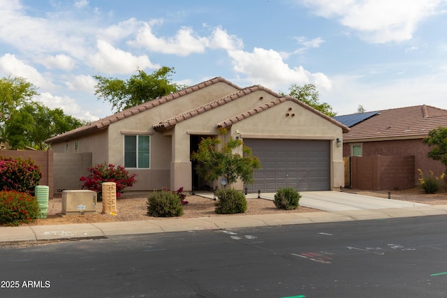 view of front of house featuring fence, a garage, stucco siding, and concrete driveway