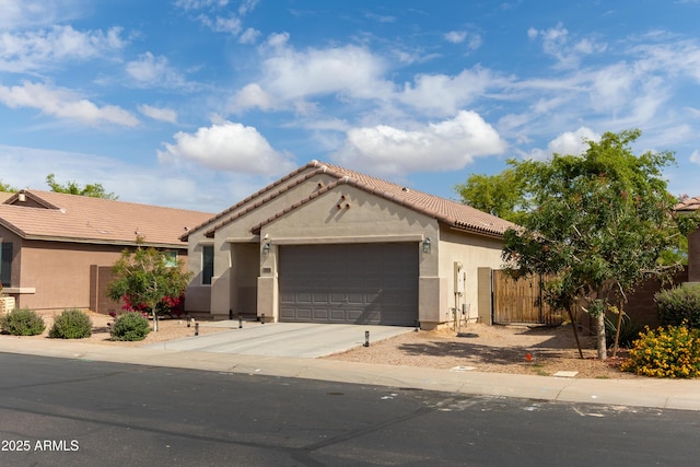 ranch-style house with fence, driveway, a garage, stucco siding, and a tiled roof