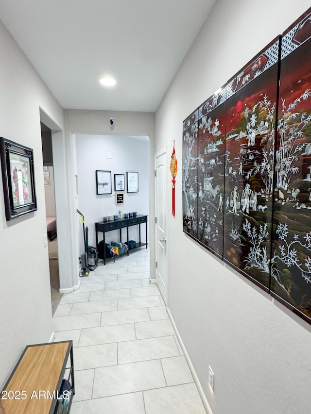 corridor featuring tile patterned flooring, baseboards, and recessed lighting