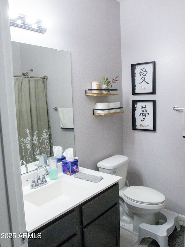 bathroom with vanity, toilet, and tile patterned flooring