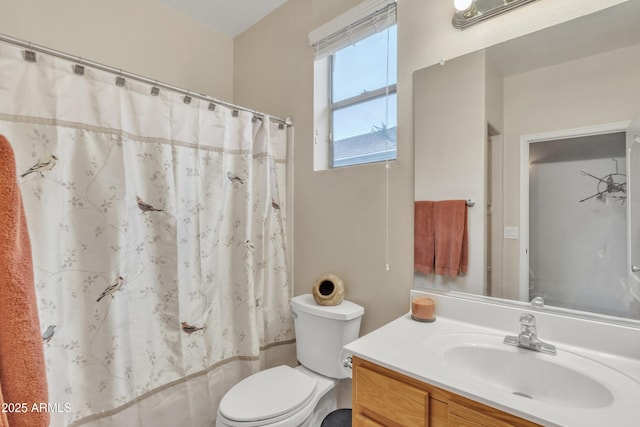 full bathroom featuring vanity, shower / bath combo with shower curtain, and toilet