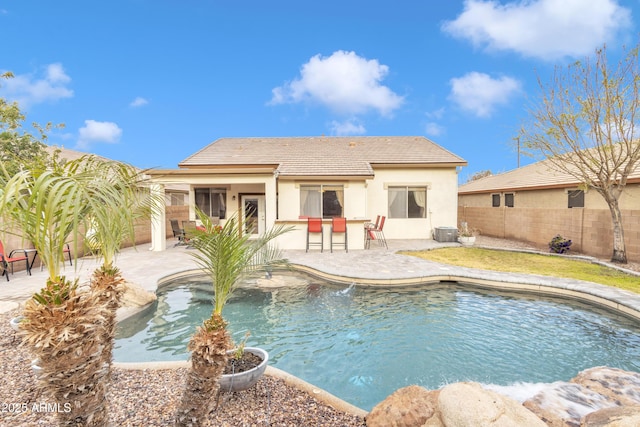 view of swimming pool with cooling unit and a patio