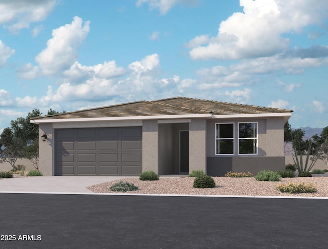 view of front of home featuring stucco siding, driveway, and an attached garage