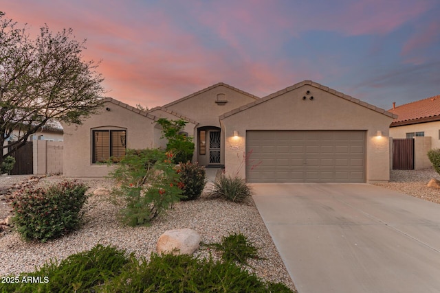 17562 W Desert Sage Dr, Goodyear, AZ 85338 - mediterranean / spanish-style home with driveway, an attached garage, stucco siding, and a tile roof