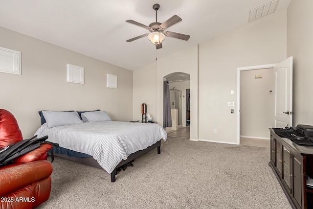 17562 W Desert Sage Dr, Goodyear, AZ 85338 - bedroom with vaulted ceiling, arched walkways, light colored carpet, baseboards, and a ceiling fan