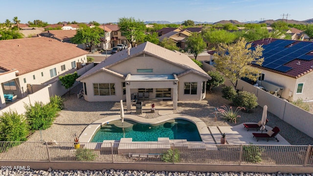 17562 W Desert Sage Dr, Goodyear, AZ 85338 - back of house with a fenced backyard, a residential view, a patio, and stucco siding