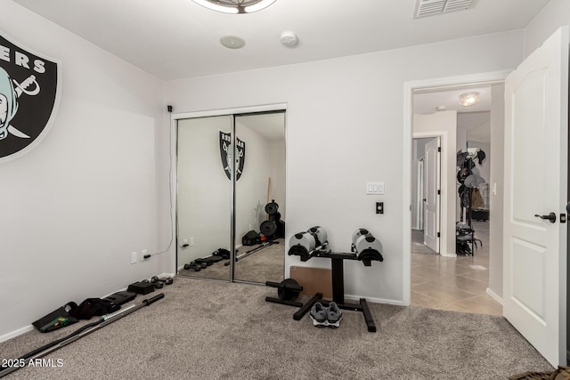 17562 W Desert Sage Dr, Goodyear, AZ 85338 - exercise room with carpet, tile patterned floors, and baseboards