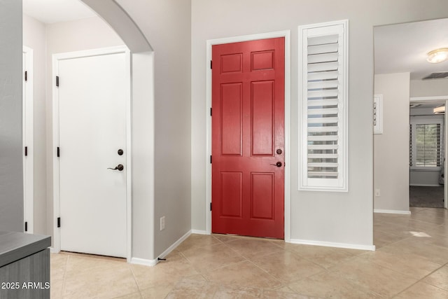17562 W Desert Sage Dr, Goodyear, AZ 85338 - entryway featuring arched walkways, light tile patterned floors, and baseboards