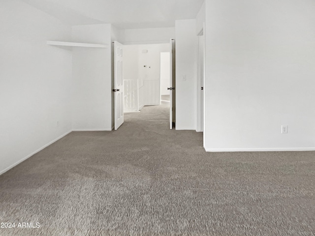 empty room featuring dark carpet