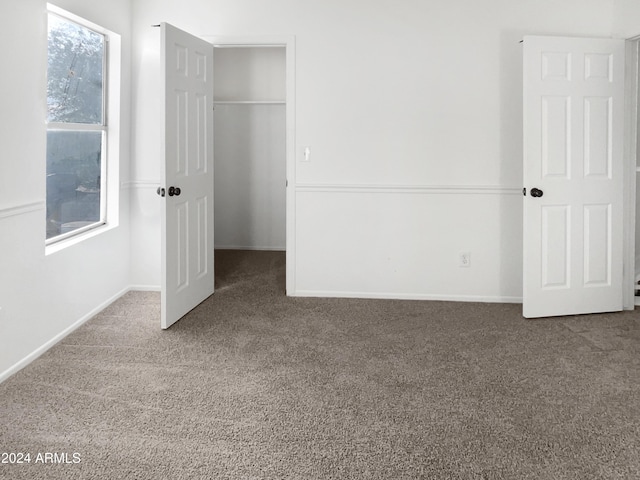 unfurnished bedroom featuring carpet and a closet