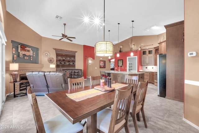 dining area with visible vents, high vaulted ceiling, a ceiling fan, light tile patterned flooring, and rail lighting