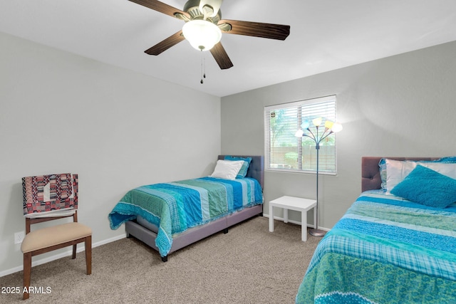 carpeted bedroom featuring ceiling fan and baseboards