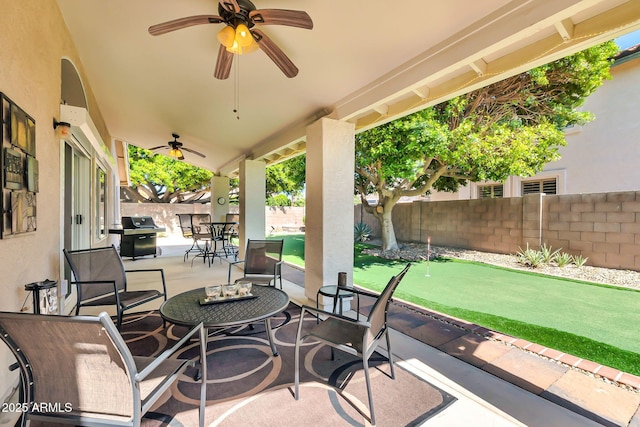 view of patio / terrace featuring a ceiling fan, outdoor dining area, a fenced backyard, and a grill