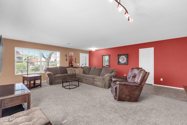 carpeted living room featuring baseboards