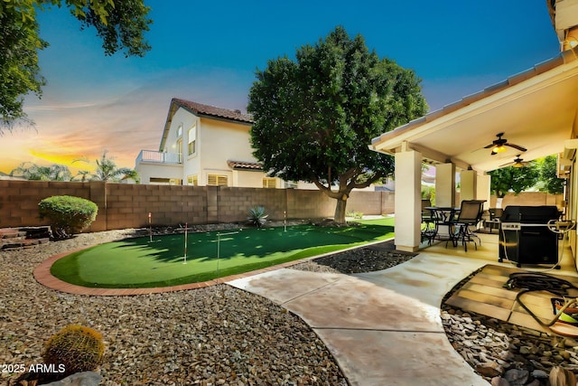 view of yard with a patio, a fenced backyard, and ceiling fan