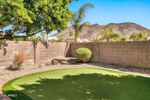 view of yard featuring a mountain view and a fenced backyard