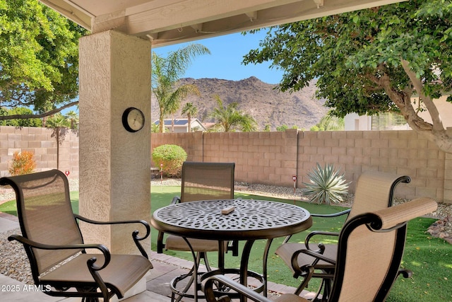 view of patio / terrace featuring a mountain view and a fenced backyard