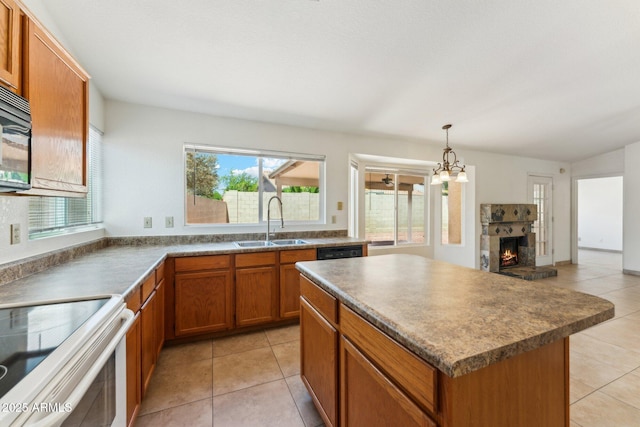 4202 E Brookwood Ct, Phoenix, AZ 85048 - kitchen featuring a sink, brown cabinets, light tile patterned floors, a kitchen island, and a stone fireplace