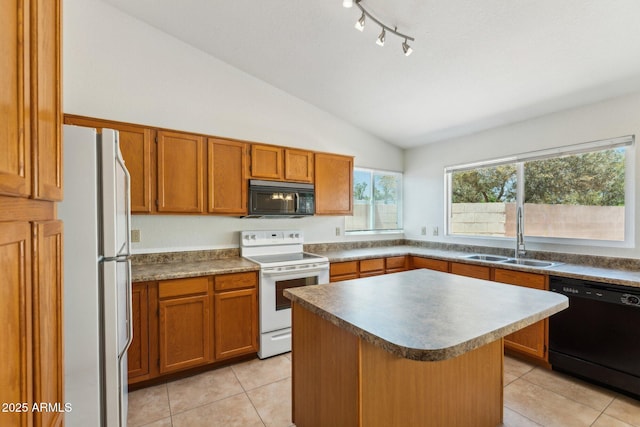 4202 E Brookwood Ct, Phoenix, AZ 85048 - kitchen with black appliances, a sink, vaulted ceiling, brown cabinetry, and light tile patterned flooring