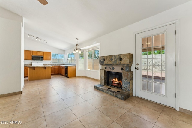4202 E Brookwood Ct, Phoenix, AZ 85048 - unfurnished living room featuring a sink, lofted ceiling, a stone fireplace, light tile patterned floors, and baseboards