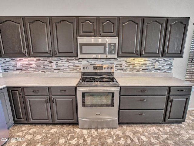 11547 W King Snake Ct, Surprise, AZ 85378 - kitchen with appliances with stainless steel finishes, light countertops, and tasteful backsplash