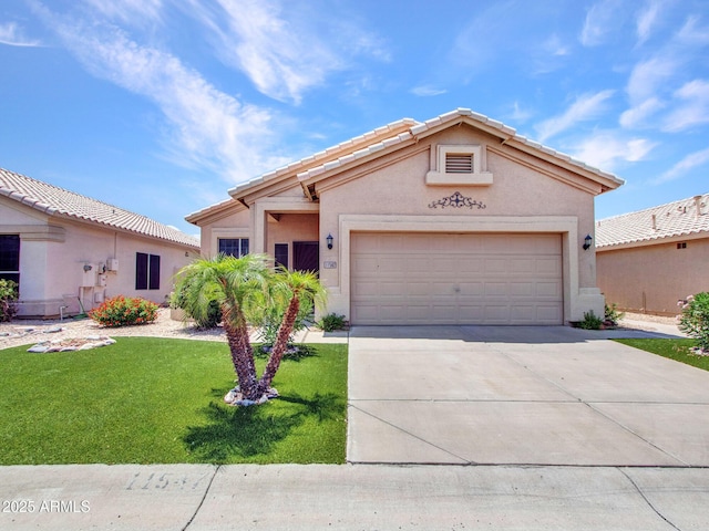 11547 W King Snake Ct, Surprise, AZ 85378 - view of front of home featuring stucco siding, concrete driveway, a front lawn, and an attached garage