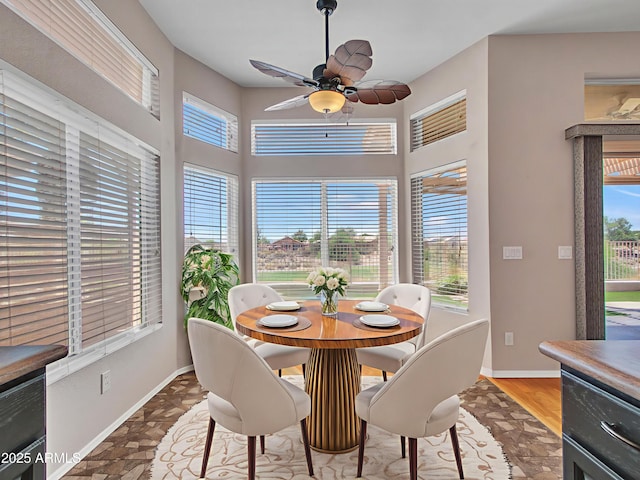 11547 W King Snake Ct, Surprise, AZ 85378 - dining space with a ceiling fan, baseboards, and a towering ceiling