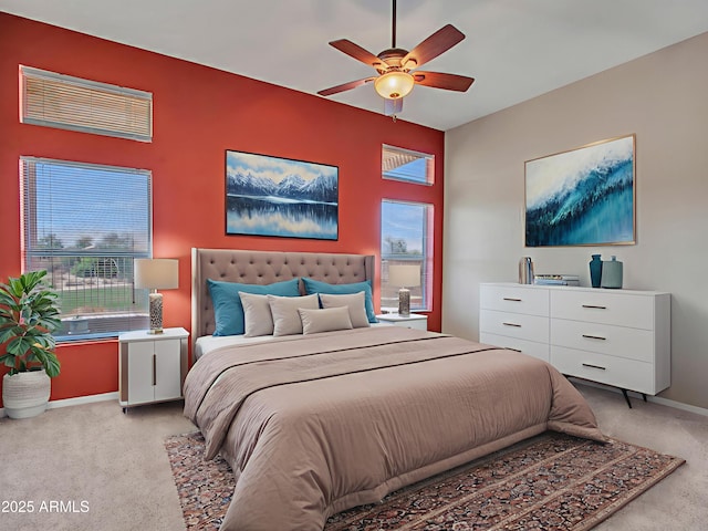 11547 W King Snake Ct, Surprise, AZ 85378 - bedroom with light carpet, multiple windows, baseboards, and ceiling fan