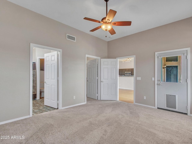 11547 W King Snake Ct, Surprise, AZ 85378 - unfurnished bedroom with carpet flooring, baseboards, ensuite bath, and ceiling fan