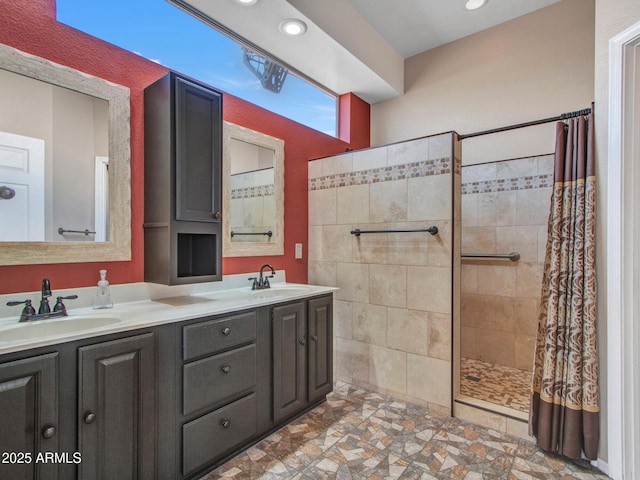 11547 W King Snake Ct, Surprise, AZ 85378 - bathroom featuring a tile shower, double vanity, and recessed lighting
